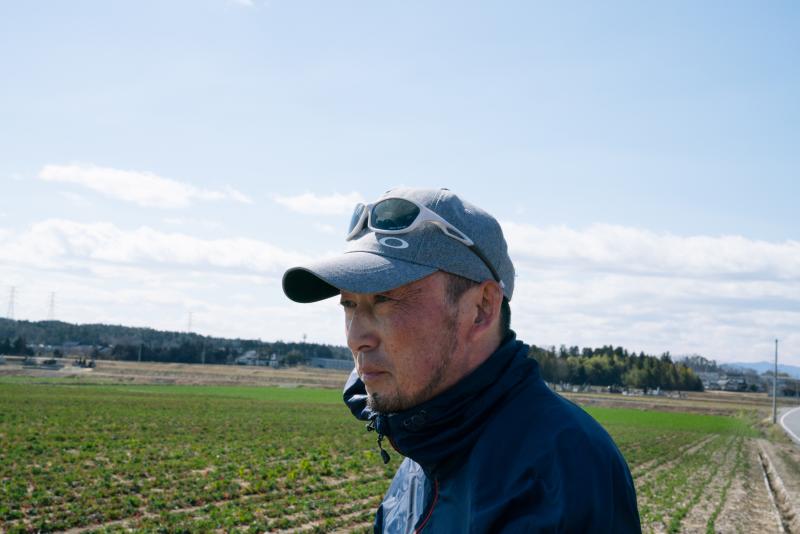 Takayuki Ueno was set to be a runner in the now postponed Olympic torch relay in Fukushima, Japan. Here he stands in the field where he is growing a flower maze for children to play in Minamisoma, Japan. The field was flooded by the 2011 tsunami and kille Takayuki Ueno was set to be a runner in the now postponed Olympic torch relay in Fukushima, Japan. Here he stands in the field where he is growing a flower maze for children to play in Minamisoma, Japan. The field was flooded by the 2011 tsunami and kille