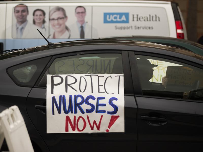 Health care workers drive by to express their support for nurses needing personal protective equipment outside the UCLA Medical Center in Santa Monica, Calif., on April 13. Health care workers drive by to express their support for nurses needing personal protective equipment outside the UCLA Medical Center in Santa Monica, Calif., on April 13.