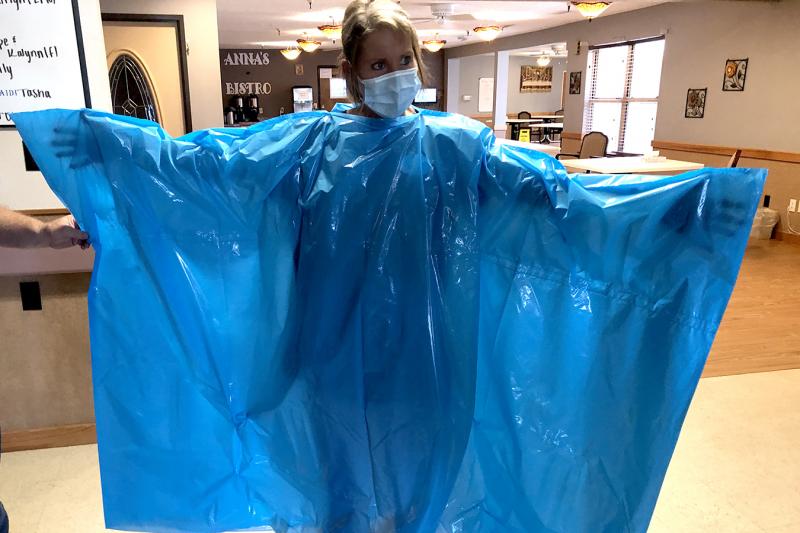 Kelly Womochil, an aide at Enterprise Estates Nursing Center in Enterprise, Kan., tries on a poncho that the Federal Emergency Management Agency is sending to nursing homes to protect against the coronavirus. Kelly Womochil, an aide at Enterprise Estates Nursing Center in Enterprise, Kan., tries on a poncho that the Federal Emergency Management Agency is sending to nursing homes to protect against the coronavirus.