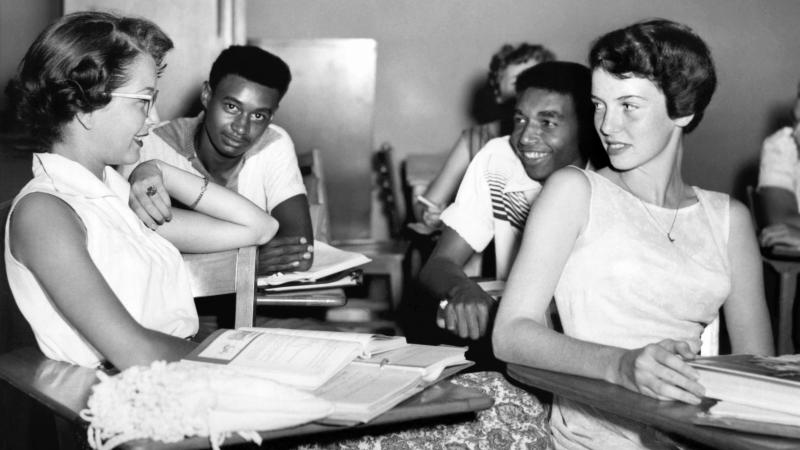 Students chat while waiting for history class to start at Oak Ridge High School in September of 1955, when the once all-white high school was desegregated by order of the Atomic Energy Commission. The Tennessee city's school board is now formally includin Students chat while waiting for history class to start at Oak Ridge High School in September of 1955, when the once all-white high school was desegregated by order of the Atomic Energy Commission. The Tennessee city's school board is now formally includin