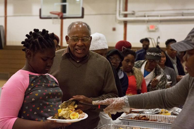 Harold Valentine (center), a local resident, attends a community Thanksgiving meal at Kennedy Recreation Center in Shaw. Harold Valentine (center), a local resident, attends a community Thanksgiving meal at Kennedy Recreation Center in Shaw.
