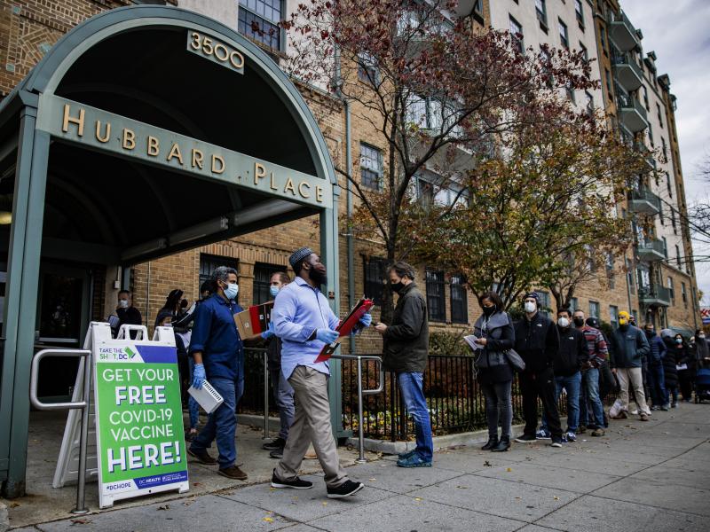 People line up outside a free COVID-19 vaccination site that opened Friday in Washington, D.C. The local health department is stepping up vaccination and booster shots as more cases of the omicron variant are being identified in the United States. People line up outside a free COVID-19 vaccination site that opened Friday in Washington, D.C. The local health department is stepping up vaccination and booster shots as more cases of the omicron variant are being identified in the United States.