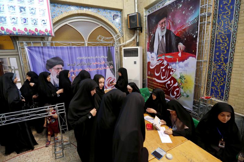 Iranian women cast their ballots for the presidential elections at a polling station at the Lorzadeh mosque in southern Tehran on Friday. Iranian women cast their ballots for the presidential elections at a polling station at the Lorzadeh mosque in southern Tehran on Friday.