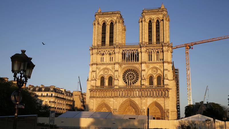 Notre Dame cathedral is seen at sunset Tuesday, after repair work stops due to the coronavirus outbreak. Wednesday marks the first anniversary of the devastating fire that destroyed many parts of the Gothic cathedral. Notre Dame cathedral is seen at sunset Tuesday, after repair work stops due to the coronavirus outbreak. Wednesday marks the first anniversary of the devastating fire that destroyed many parts of the Gothic cathedral.
