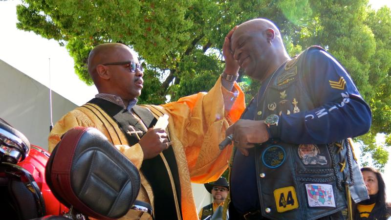 Reverend Jeff Moore blesses a biker at the Buffalo Soldiers Motorcycle Club rally in San Jose, Calif. Reverend Jeff Moore blesses a biker at the Buffalo Soldiers Motorcycle Club rally in San Jose, Calif.
