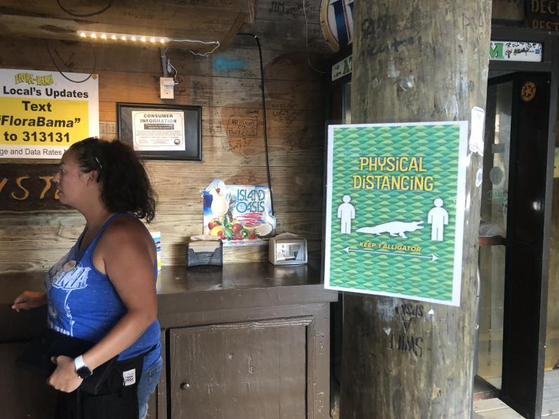 Signs posted at Flora-Bama show how far apart people should stand to maintain social distancing — an alligator's length. Signs posted at Flora-Bama show how far apart people should stand to maintain social distancing — an alligator's length.