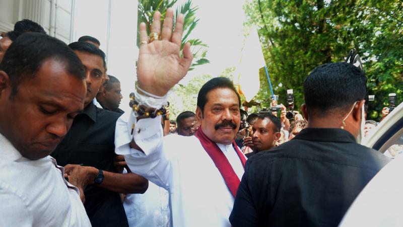 Sri Lanka's newly appointed prime minister, Mahinda Rajapaksa, waves to supporters Monday in the capital, Colombo. The man he intends replace, Ranil Wickremesinghe, demanded that lawmakers be allowed to end his standoff with the country's president. Sri Lanka's newly appointed prime minister, Mahinda Rajapaksa, waves to supporters Monday in the capital, Colombo. The man he intends replace, Ranil Wickremesinghe, demanded that lawmakers be allowed to end his standoff with the country's president.
