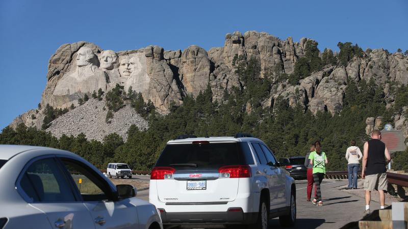 During the 2013 shutdown, tourists have to look at Mount Rushmore from the highway because the national memorial in Keystone, S.D., was closed. During the 2013 shutdown, tourists have to look at Mount Rushmore from the highway because the national memorial in Keystone, S.D., was closed.