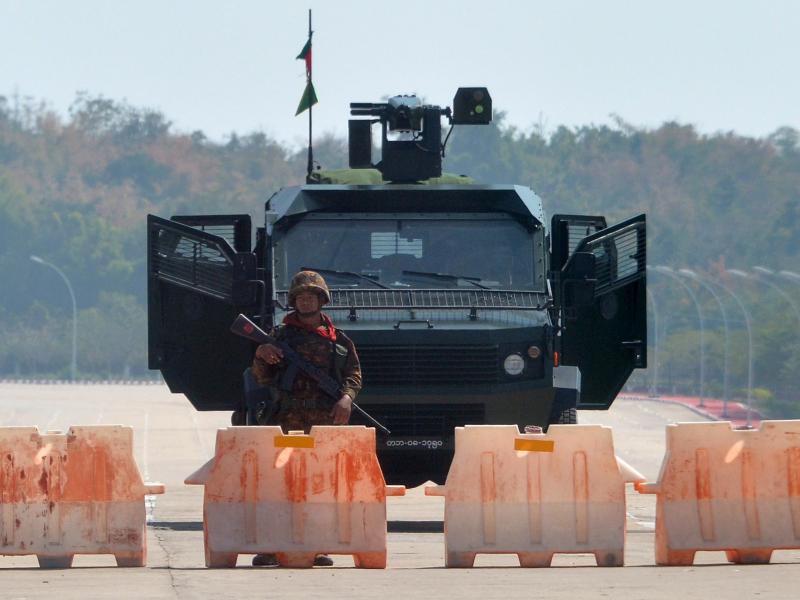 A soldier stands guard on a blockaded road to Myanmar's parliament in Naypyidaw on Monday, after the military detained the country's de facto leader Aung San Suu Kyi and other officials and activists. A soldier stands guard on a blockaded road to Myanmar's parliament in Naypyidaw on Monday, after the military detained the country's de facto leader Aung San Suu Kyi and other officials and activists.
