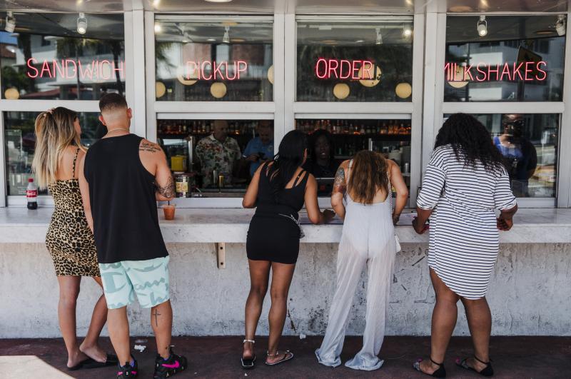 Customers at this take-out window in Miami on March 20 were not practicing social distancing. Customers at this take-out window in Miami on March 20 were not practicing social distancing.