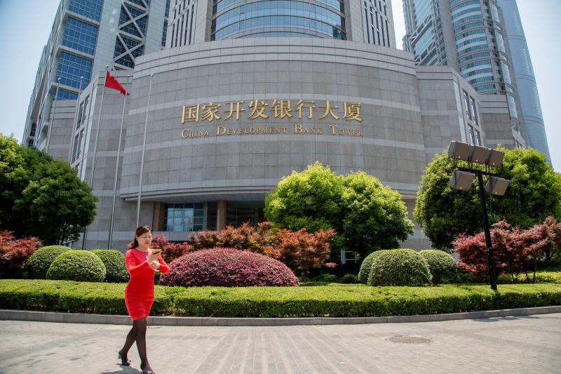 A woman walks in front of the China Development Bank tower in the Pudong district of Shanghai in 2015. That and the Export-Import Bank of China have provided nearly $1 trillion in financing to foreign governments since the early 2000s. A woman walks in front of the China Development Bank tower in the Pudong district of Shanghai in 2015. That and the Export-Import Bank of China have provided nearly $1 trillion in financing to foreign governments since the early 2000s.