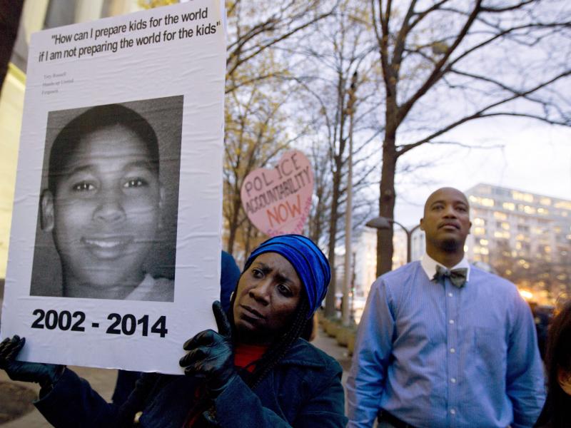 Tomiko Shine holds up a picture of Tamir Rice during a protest in Washington, D.C. Tomiko Shine holds up a picture of Tamir Rice during a protest in Washington, D.C.