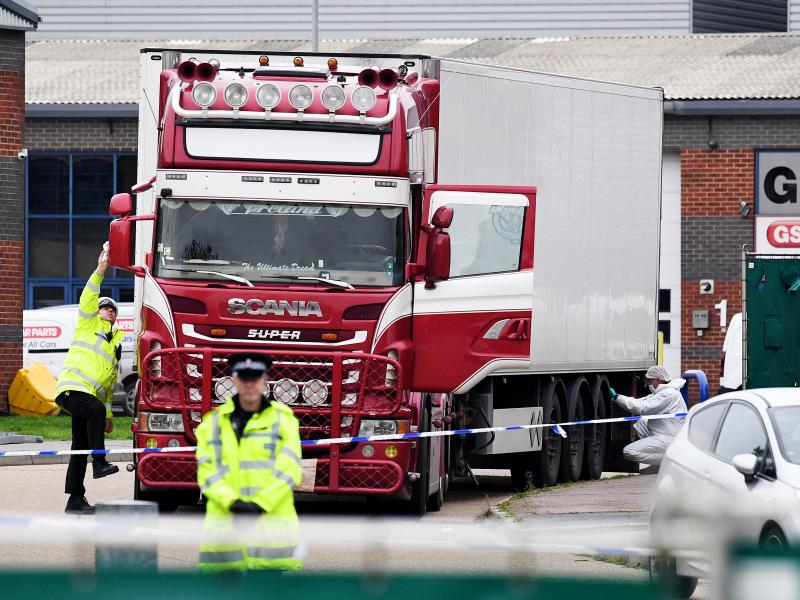 Police and forensic officers investigate a truck and refrigerated trailer where 39 bodies were discovered in Thurrock, England. Police and forensic officers investigate a truck and refrigerated trailer where 39 bodies were discovered in Thurrock, England.