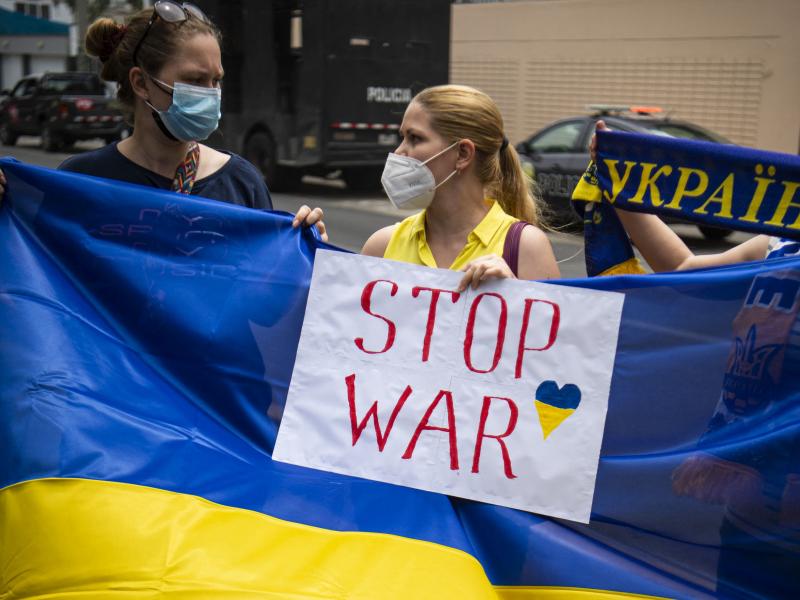 Ukrainian citizens hold posters and national flags during a demonstration in support of Ukraine outside the Russian Embassy in Lima, Peru, on Friday. Ukrainian citizens hold posters and national flags during a demonstration in support of Ukraine outside the Russian Embassy in Lima, Peru, on Friday.