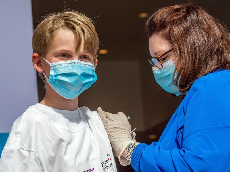 Charles Muro, 13, is inoculated at a mass vaccination center in Hartford, Conn., on May 13. Charles Muro, 13, is inoculated at a mass vaccination center in Hartford, Conn., on May 13.
