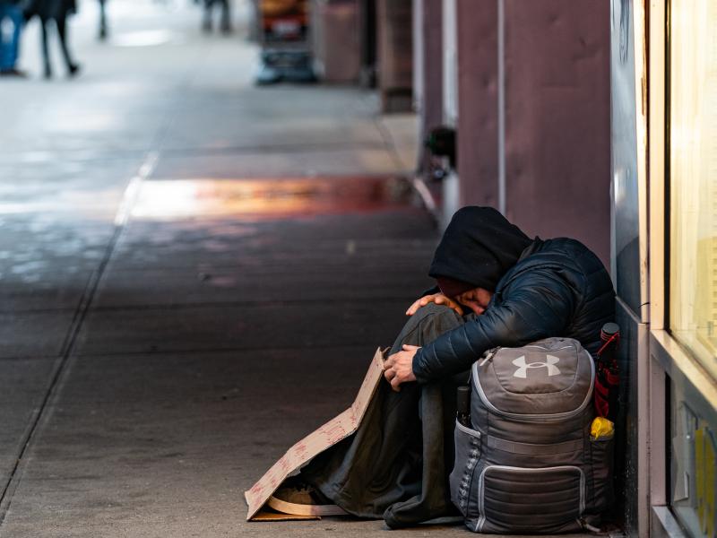 A person sleeps on a sidewalk near New York's Times Square this past week. A new report says more and more American cities are passing laws that make it illegal to sleep outside, on the street, in a park or in your own car. A person sleeps on a sidewalk near New York's Times Square this past week. A new report says more and more American cities are passing laws that make it illegal to sleep outside, on the street, in a park or in your own car.