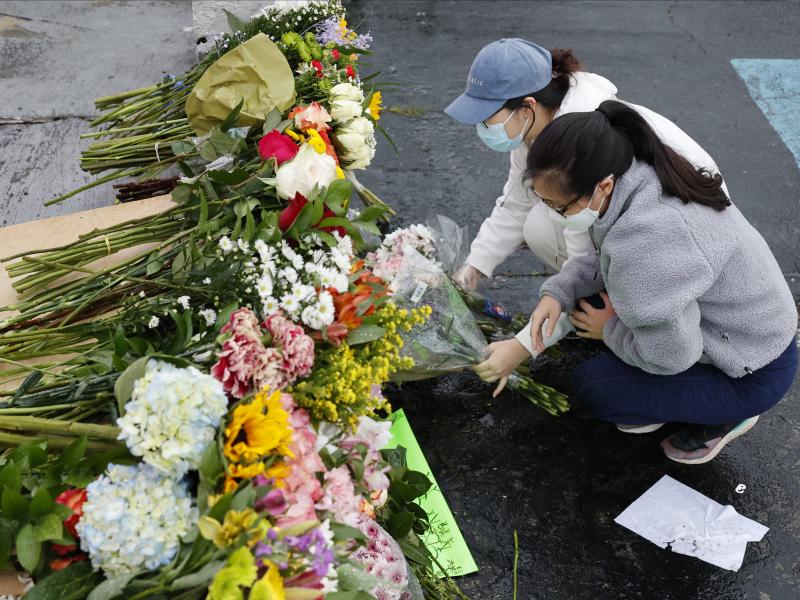 Jenny Choi (left) and Kristi You place flowers Wednesday at the entrance of Gold Spa, one of three locations where deadly shootings happened in the Atlanta area this week. Jenny Choi (left) and Kristi You place flowers Wednesday at the entrance of Gold Spa, one of three locations where deadly shootings happened in the Atlanta area this week.