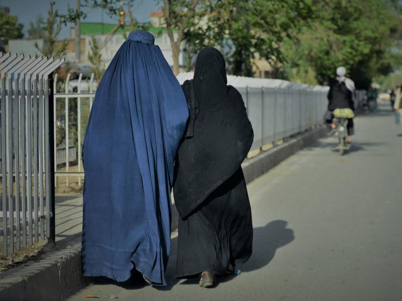 Women wearing a burqa (left) and a niqab (right) walk along a street in Kabul on May 7. Women wearing a burqa (left) and a niqab (right) walk along a street in Kabul on May 7.