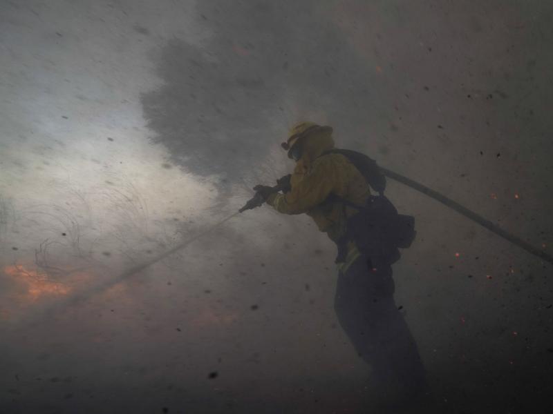 A firefighter battles the Silverado Fire Monday,in Irvine, Calif. The wildfire forced evacuation orders for 60,000 people in Southern California. A firefighter battles the Silverado Fire Monday,in Irvine, Calif. The wildfire forced evacuation orders for 60,000 people in Southern California.