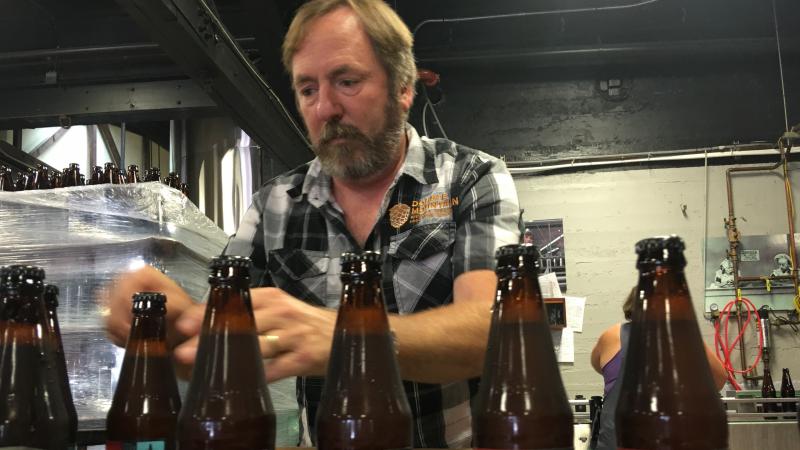 Double Mountain Brewery founder Matt Swihart grabs freshly bottled pale ale from the bottling line in Hood River. The ale is among the first to be sold in Oregon's new refillable beer bottles. Double Mountain Brewery founder Matt Swihart grabs freshly bottled pale ale from the bottling line in Hood River. The ale is among the first to be sold in Oregon's new refillable beer bottles.