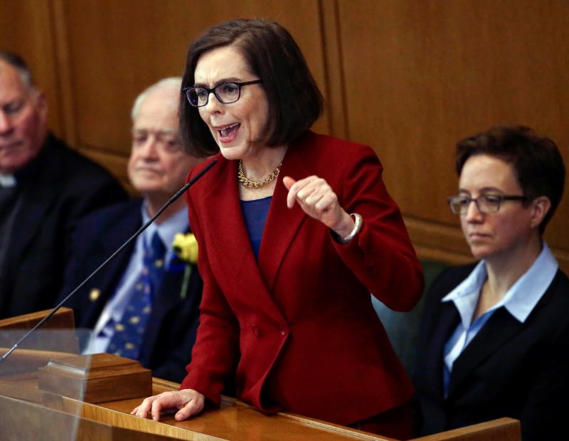 Oregon Gov. Kate Brown, D, center, recently signed a bill into law that would require insurers in the state to cover reproductive health services. Oregon Gov. Kate Brown, D, center, recently signed a bill into law that would require insurers in the state to cover reproductive health services.