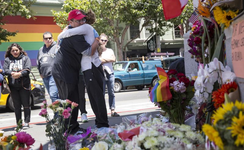 Larry Pascua hugs a friend Monday in San Francisco amid flowers and other items left as a memorial to those killed in the attack on a gay nightclub in Orlando, Fla. Larry Pascua hugs a friend Monday in San Francisco amid flowers and other items left as a memorial to those killed in the attack on a gay nightclub in Orlando, Fla.