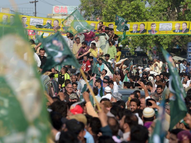 Supporters of ousted Pakistani Prime Minister Nawaz Sharif march toward Lahore's airport ahead of his arrival from London on Friday. Supporters of ousted Pakistani Prime Minister Nawaz Sharif march toward Lahore's airport ahead of his arrival from London on Friday.