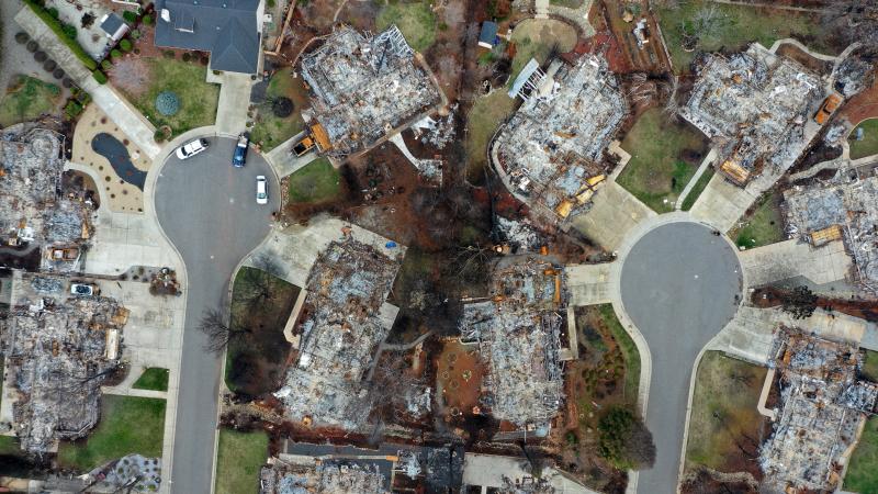 PG&E says it will pay $11 billion to resolve insurance companies' claims from the 2017 Northern California wildfires and the 2018 Camp Fire. Here, destroyed homes are seen in Paradise, Calif., where the Camp Fire raged last November. PG&E says it will pay $11 billion to resolve insurance companies' claims from the 2017 Northern California wildfires and the 2018 Camp Fire. Here, destroyed homes are seen in Paradise, Calif., where the Camp Fire raged last November.