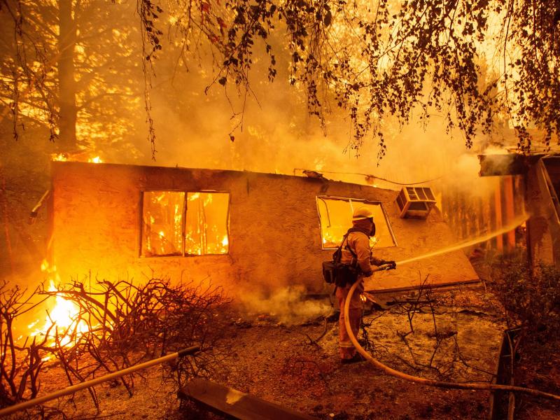 Firefighters battle flames at a burning apartment complex in Paradise, Calif., in November. PG&E could shut down power to as many as 5.4 million customers during extreme weather conditions. Firefighters battle flames at a burning apartment complex in Paradise, Calif., in November. PG&E could shut down power to as many as 5.4 million customers during extreme weather conditions.