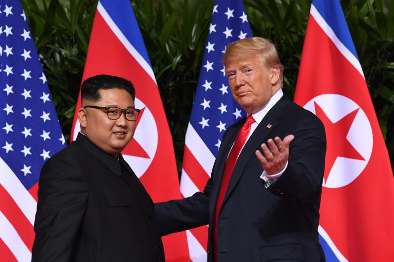 President Trump gestures to reporters as he meets with North Korea's leader Kim Jong Un at the start of the U.S.-North Korea summit in Singapore on Tuesday. President Trump gestures to reporters as he meets with North Korea's leader Kim Jong Un at the start of the U.S.-North Korea summit in Singapore on Tuesday.