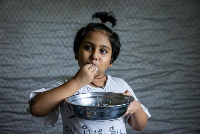 Hosna Ali, 6, eats rice with dried fish at home in Seleyang, Malaysia. Her dad, Mohd Ali, says the family has not been getting enough nutrients during the pandemic. Hosna Ali, 6, eats rice with dried fish at home in Seleyang, Malaysia. Her dad, Mohd Ali, says the family has not been getting enough nutrients during the pandemic.