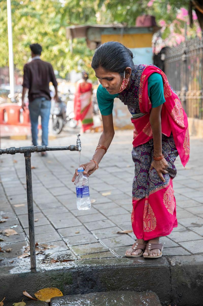 A woman fills a bottle from the tap at the Seth Gangalal V. Mulji Nandlal fountain. Researchers and water rights activist say the pandemic has exacerbated the huge inequality in Mumbai's water supply, with lower-income families struggling to find affordab A woman fills a bottle from the tap at the Seth Gangalal V. Mulji Nandlal fountain. Researchers and water rights activist say the pandemic has exacerbated the huge inequality in Mumbai's water supply, with lower-income families struggling to find affordab