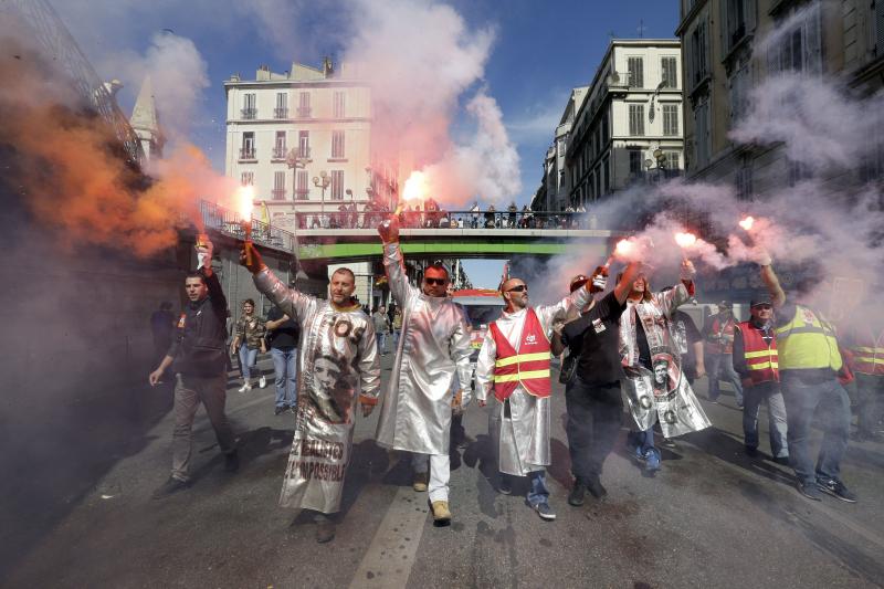 Steelworkers from the ArcelorMittal steel plant in Fos-sur-Mer, France, burn flares during a nationwide day of protest on Tuesday. Steelworkers from the ArcelorMittal steel plant in Fos-sur-Mer, France, burn flares during a nationwide day of protest on Tuesday.
