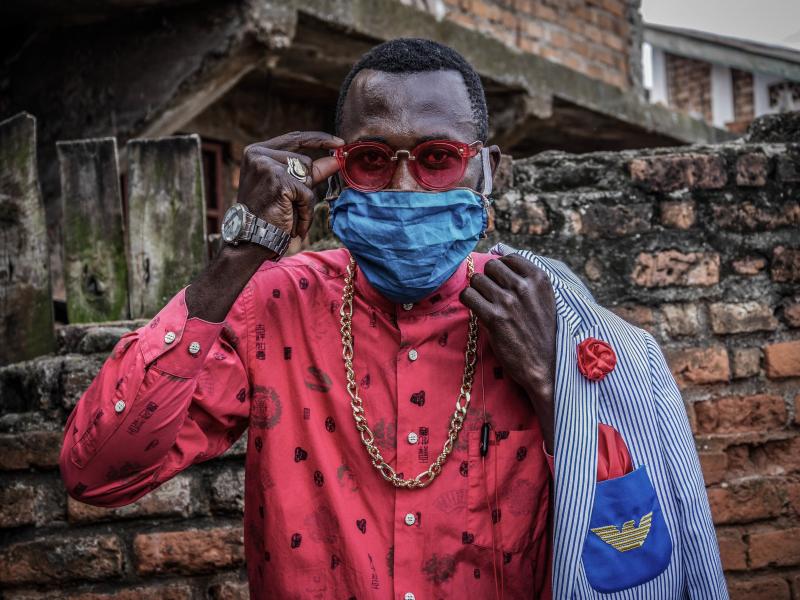 Anglebert Maurice Kakuja, 29, a Sapeur, or Congolese dandy, shows off his fashion sense while wearing a homemade mask in the eastern Congolese city of Bukavu. Sapeurs take their name from the acronym for their group: Societe des Ambianceurs et des Personn Anglebert Maurice Kakuja, 29, a Sapeur, or Congolese dandy, shows off his fashion sense while wearing a homemade mask in the eastern Congolese city of Bukavu. Sapeurs take their name from the acronym for their group: Societe des Ambianceurs et des Personn