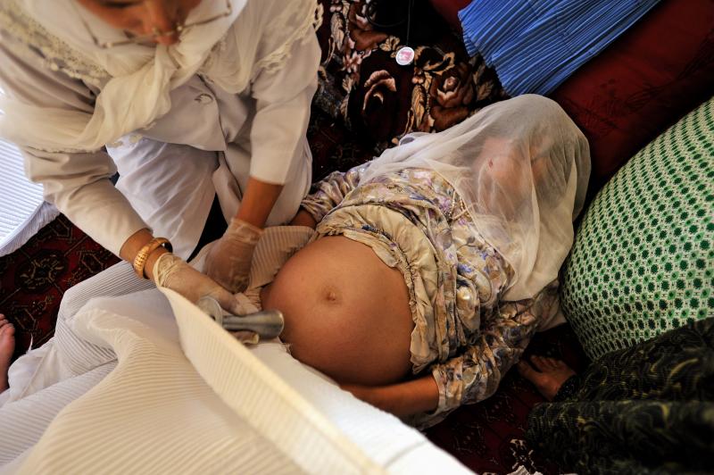 Addario's coverage of maternal mortality took her to a remote village in Badakhshan province, Afghanistan in 2009, where she photographed a midwife giving a prenatal check in a private home. "In these areas someone will announce that a doctor and a midwif Addario's coverage of maternal mortality took her to a remote village in Badakhshan province, Afghanistan in 2009, where she photographed a midwife giving a prenatal check in a private home. "In these areas someone will announce that a doctor and a midwif