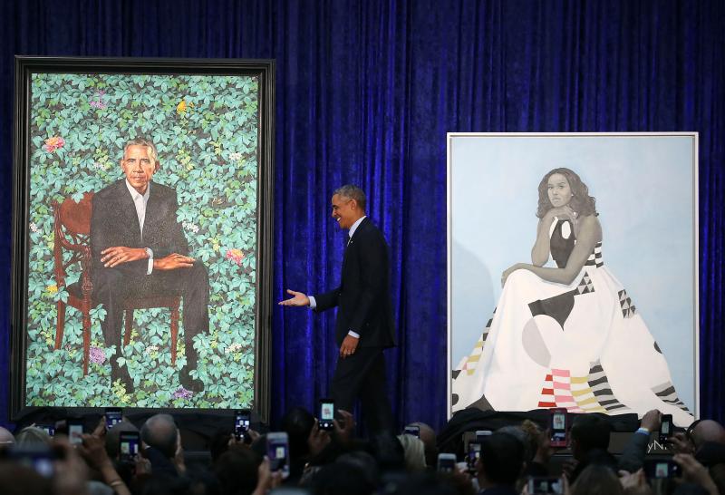 Obama stands between the portraits. His will be permanently installed in the "America's Presidents" exhibit at the National Portrait Gallery in Washington, D.C. Obama stands between the portraits. His will be permanently installed in the "America's Presidents" exhibit at the National Portrait Gallery in Washington, D.C.