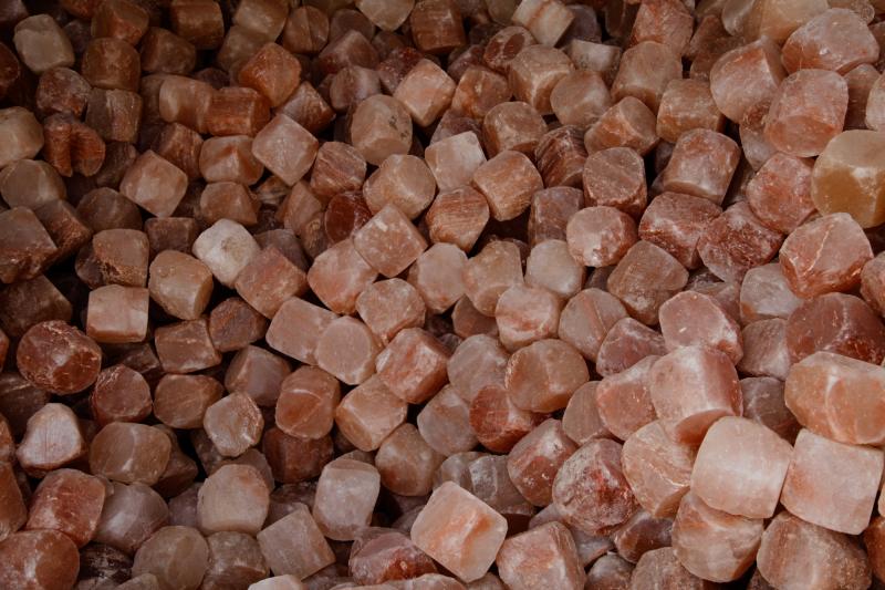 A pile of rough-hewn pink Himalayan salt cubes. A pile of rough-hewn pink Himalayan salt cubes.