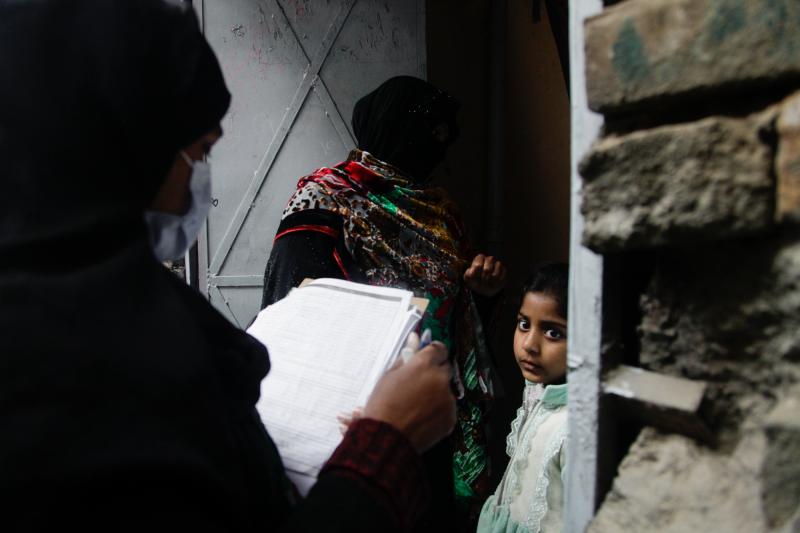 Polio vaccinator Zeenat Parveen, holding the clipboard, and a volunteer go door-to-door to reach children in Rawalpindi, a city near the Pakistani capital of Islamabad. Polio vaccinator Zeenat Parveen, holding the clipboard, and a volunteer go door-to-door to reach children in Rawalpindi, a city near the Pakistani capital of Islamabad.