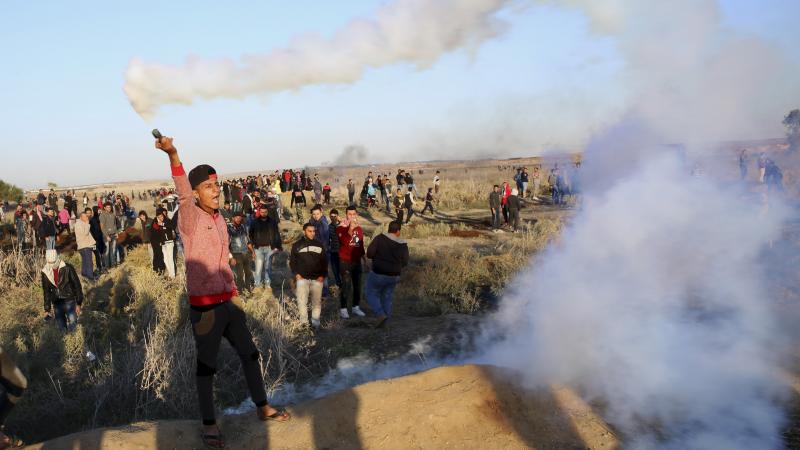 A Palestinian protester throws back a tear gas canister that was fired by Israeli soldiers during clashes on the Israeli border after a protest against President Trump's decision to recognize Jerusalem as the capital of Israel. A Palestinian protester throws back a tear gas canister that was fired by Israeli soldiers during clashes on the Israeli border after a protest against President Trump's decision to recognize Jerusalem as the capital of Israel.