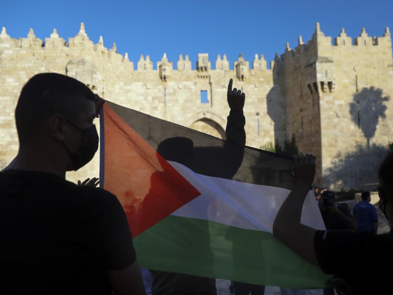 Demonstrators wave the Palestinian flag during a protest in Damascus Gate, just outside Jerusalem's Old City on June 19. Palestinians and Jewish settlers hurled stones, chairs and fireworks at each other in a tense Jerusalem neighborhood, where settler gr Demonstrators wave the Palestinian flag during a protest in Damascus Gate, just outside Jerusalem's Old City on June 19. Palestinians and Jewish settlers hurled stones, chairs and fireworks at each other in a tense Jerusalem neighborhood, where settler gr