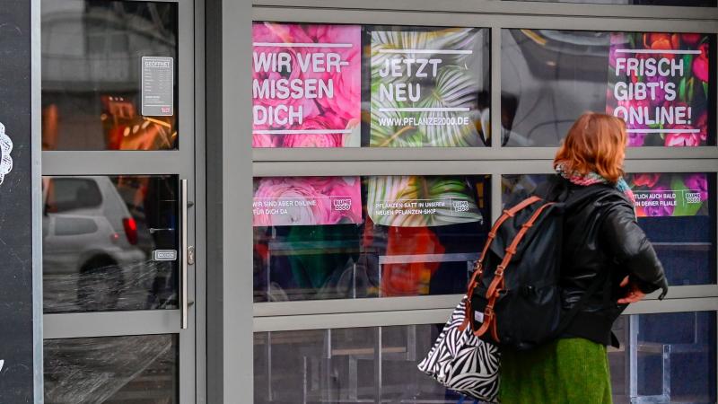 A woman walks past a closed flower shop in Berlin on Thursday. A research group noted more than 1,200 new words in German inspired by the pandemic. A woman walks past a closed flower shop in Berlin on Thursday. A research group noted more than 1,200 new words in German inspired by the pandemic.