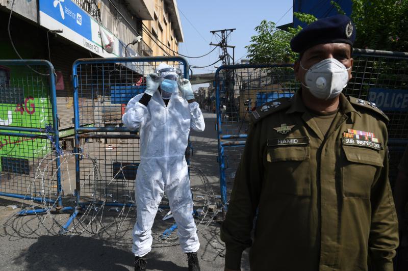 A policeman guards a street sealed by the authorities at a residential area in Lahore on June 17 as COVID-19 cases continue to rise. A policeman guards a street sealed by the authorities at a residential area in Lahore on June 17 as COVID-19 cases continue to rise.