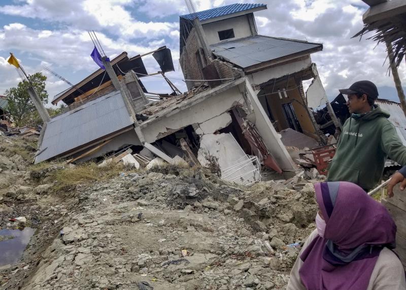 Vera Rahayu Putri and her husband Faizal, who goes by one name, survey earthquake damage in their Palu neighborhood of Petobo, now covered by mudslides. Putri's 9-year-old son, Raldi, is among thousands of children who are unaccounted for. Vera Rahayu Putri and her husband Faizal, who goes by one name, survey earthquake damage in their Palu neighborhood of Petobo, now covered by mudslides. Putri's 9-year-old son, Raldi, is among thousands of children who are unaccounted for.