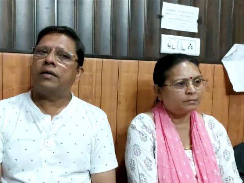 This image from video shows Sanjeev Ranjan Prasad, a 61-year-old retired government officer, and his wife Sadhana Prasad as they wait at a lawyer's chamber in Haridwar, India, on Thursday. The couple has sued their son and daughter-in-law, demanding a gra This image from video shows Sanjeev Ranjan Prasad, a 61-year-old retired government officer, and his wife Sadhana Prasad as they wait at a lawyer's chamber in Haridwar, India, on Thursday. The couple has sued their son and daughter-in-law, demanding a gra