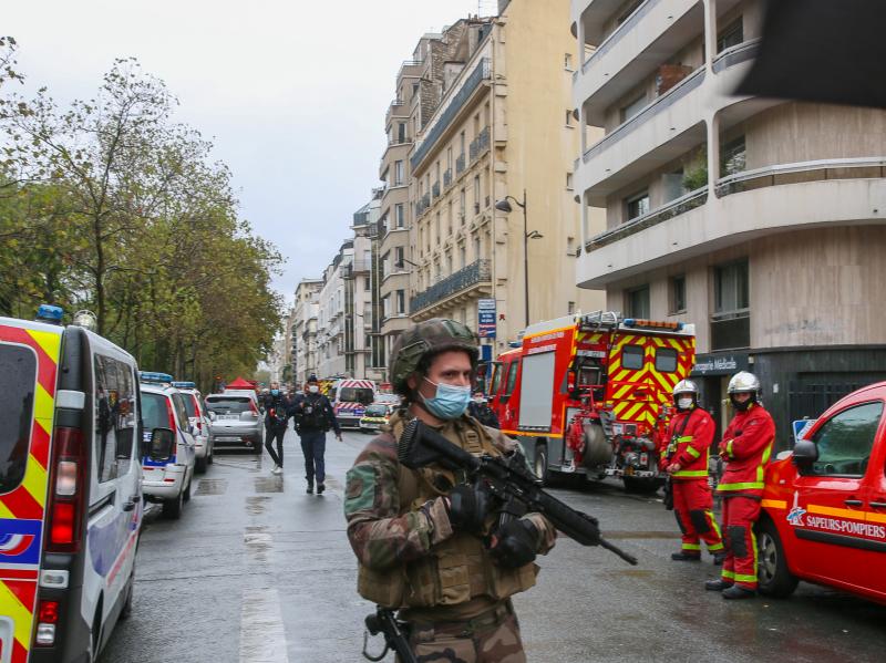 An officer of the French National Gendarmerie guards an area near the former Paris offices of satirical newspaper Charlie Hebdo, where two people were wounded Friday in an attack with a sharp object that one witness described as a hatchet. An officer of the French National Gendarmerie guards an area near the former Paris offices of satirical newspaper Charlie Hebdo, where two people were wounded Friday in an attack with a sharp object that one witness described as a hatchet.