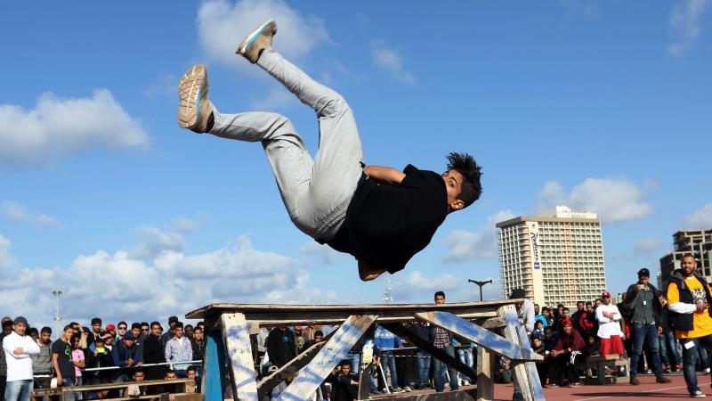 A Libyan youth displays his skills in parkour, an extreme sport, during a friendly competition in Tripoli on March 7, 2014. A Libyan youth displays his skills in parkour, an extreme sport, during a friendly competition in Tripoli on March 7, 2014.