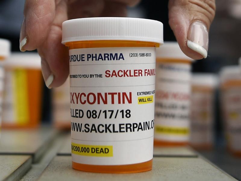 Family and friends who lost loved ones to OxyContin and opioid overdoses left pill bottles in protest outside the Stamford, Conn., headquarters of Purdue Pharma in August 2018. Family and friends who lost loved ones to OxyContin and opioid overdoses left pill bottles in protest outside the Stamford, Conn., headquarters of Purdue Pharma in August 2018.