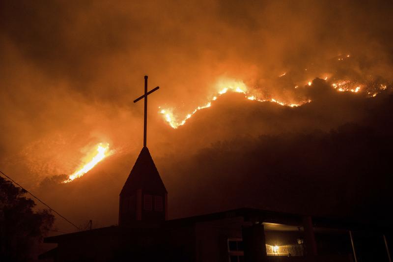 Flames from a wildfire advance down a hillside near the Springs of Life Church in Casitas Springs, Calif. Flames from a wildfire advance down a hillside near the Springs of Life Church in Casitas Springs, Calif.