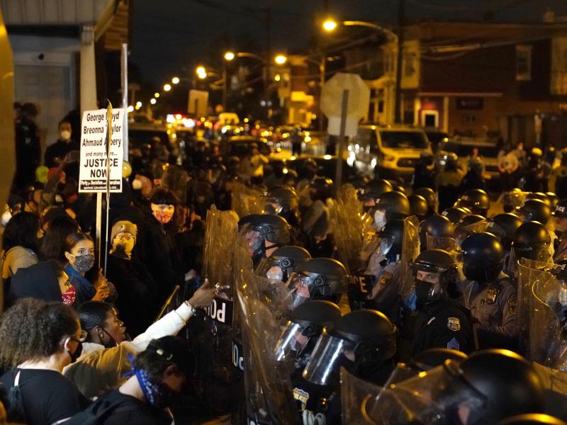 Protesters confront police during a march Tuesday in Philadelphia following this week's fatal police shooting of Walter Wallace Jr., a 27-year-old Black man. Protesters confront police during a march Tuesday in Philadelphia following this week's fatal police shooting of Walter Wallace Jr., a 27-year-old Black man.