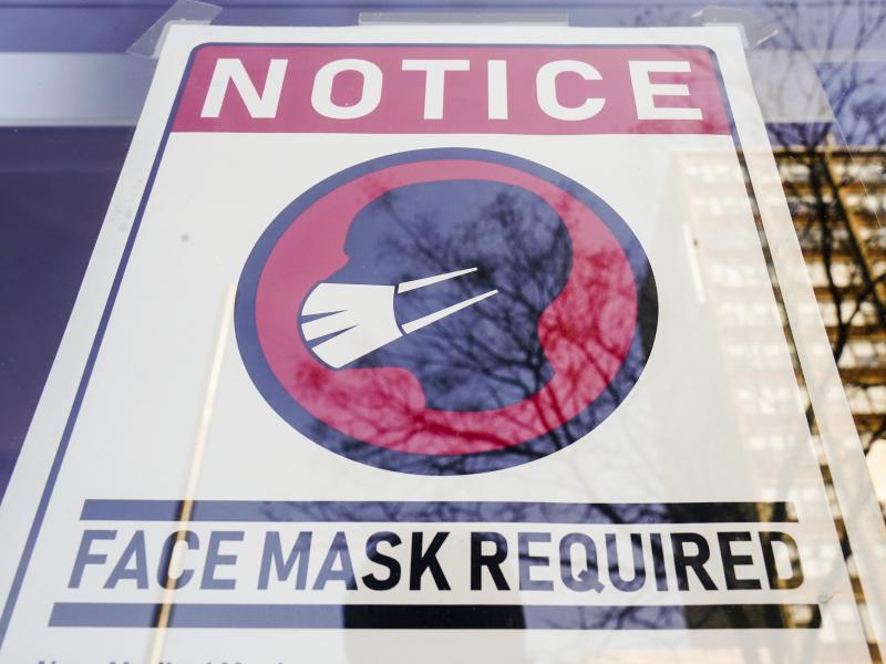 A sign requiring masks as a precaution against the spread of the coronavirus is taped on a storefront in Philadelphia on Feb. 16. A sign requiring masks as a precaution against the spread of the coronavirus is taped on a storefront in Philadelphia on Feb. 16.